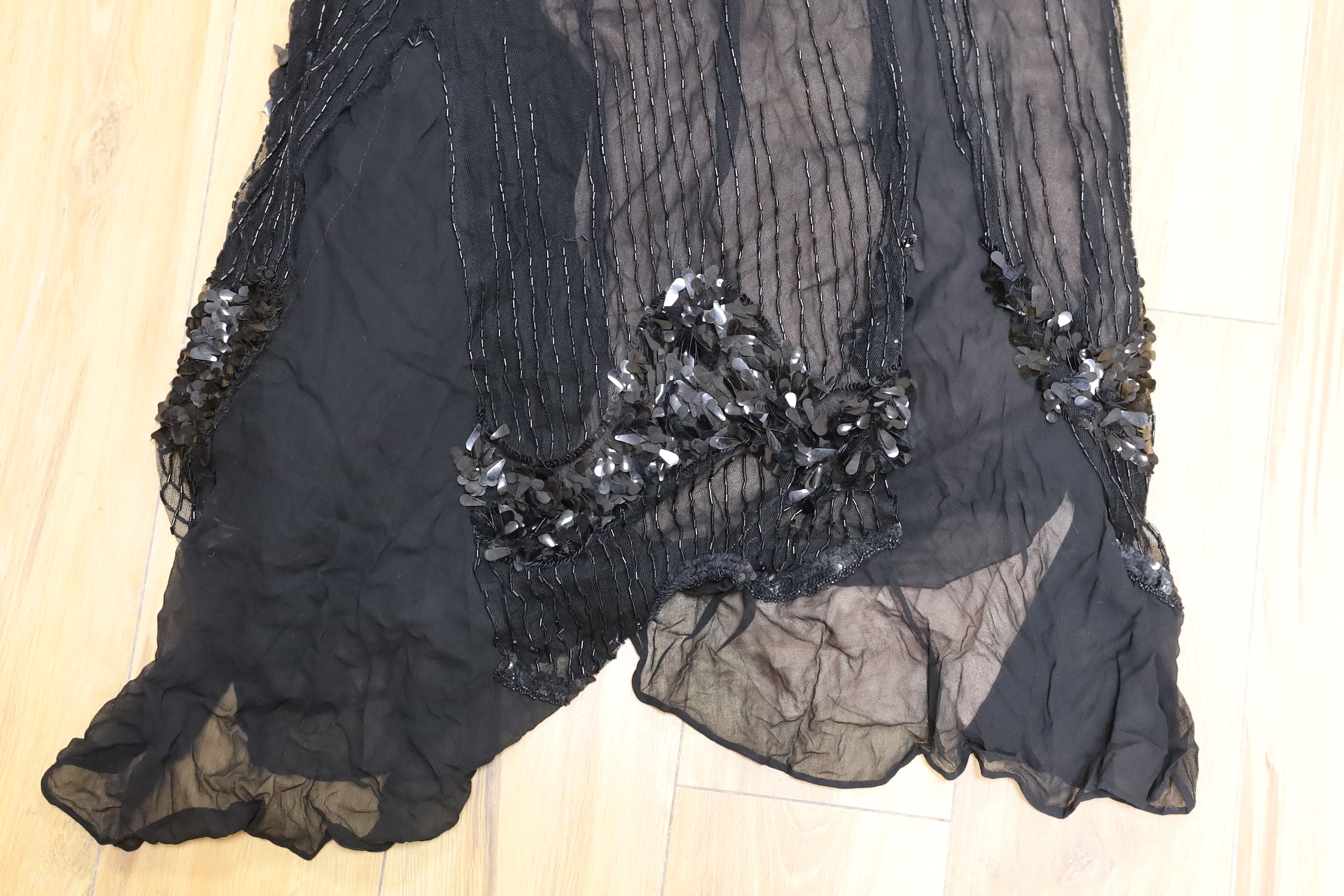 An early 20th century ladies black silk net and chiffon, beaded and sequin evening dress